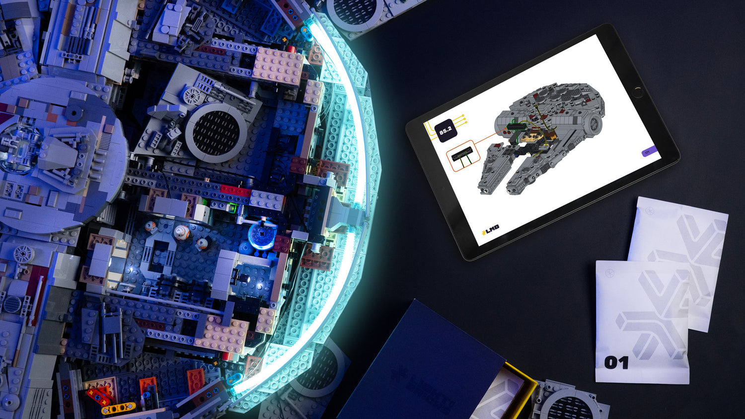 LEGO model of a spaceship with digital tablet displaying LEGO set on dark surface